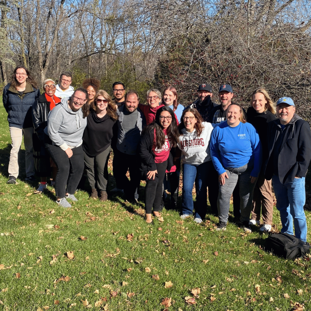 The group of writers outside in the sunshine posing for a group photo. 